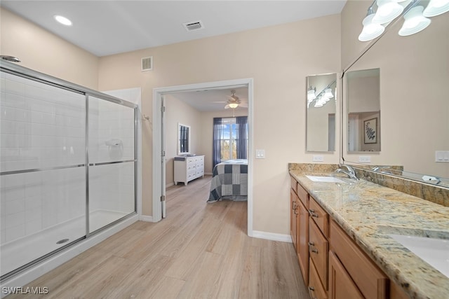 bathroom with vanity, an enclosed shower, hardwood / wood-style flooring, and ceiling fan