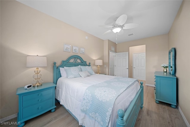 bedroom with ceiling fan and light wood-type flooring