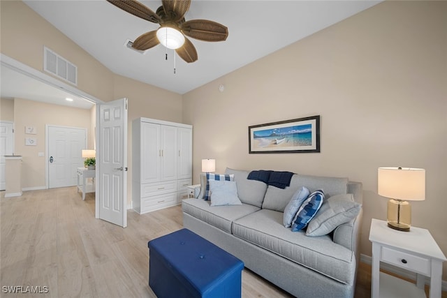 living room with light hardwood / wood-style flooring and ceiling fan