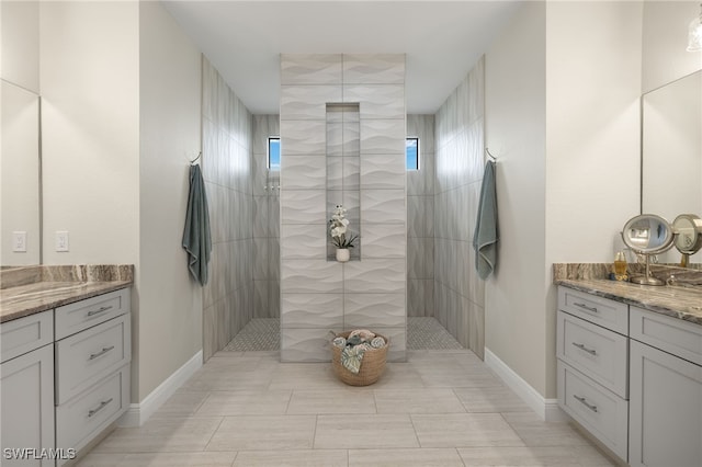 bathroom with vanity and tiled shower