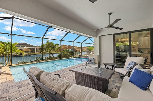 view of pool with an outdoor hangout area, a water view, a patio, and ceiling fan