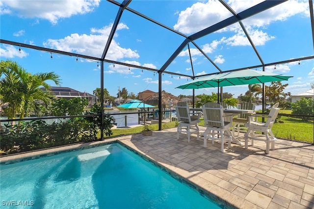 view of pool featuring a patio area and glass enclosure