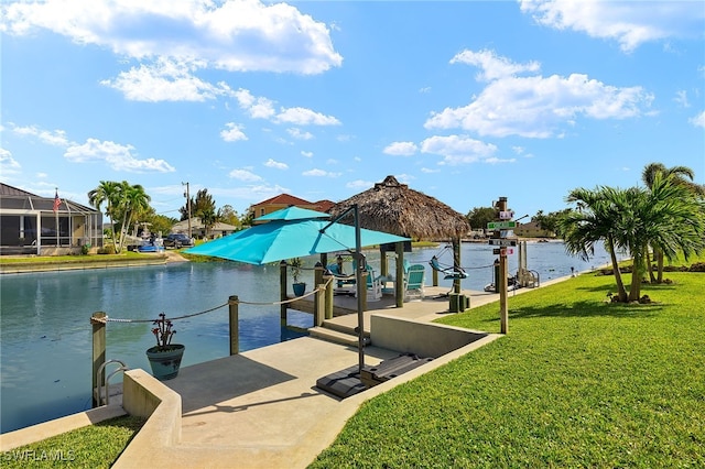 dock area with a lawn and a water view