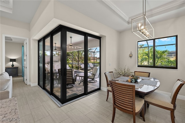 dining area featuring french doors, a healthy amount of sunlight, and ceiling fan with notable chandelier