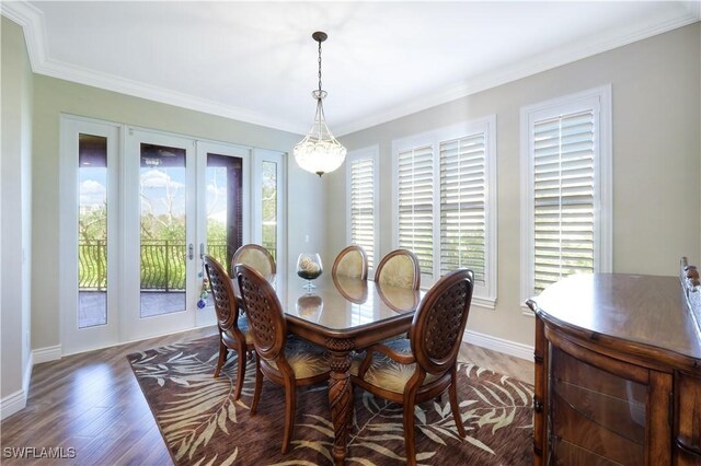 dining area with ornamental molding, plenty of natural light, and dark hardwood / wood-style flooring