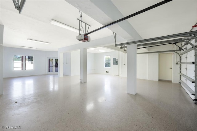 garage featuring electric panel and a garage door opener