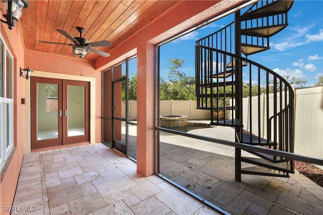 unfurnished sunroom with french doors, ceiling fan, and wooden ceiling