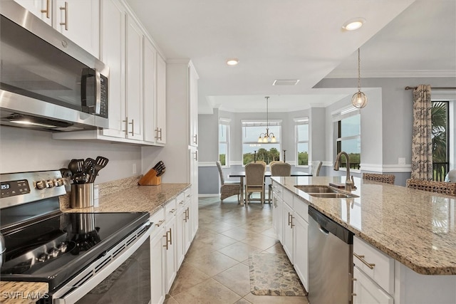 kitchen featuring ornamental molding, white cabinetry, appliances with stainless steel finishes, hanging light fixtures, and sink