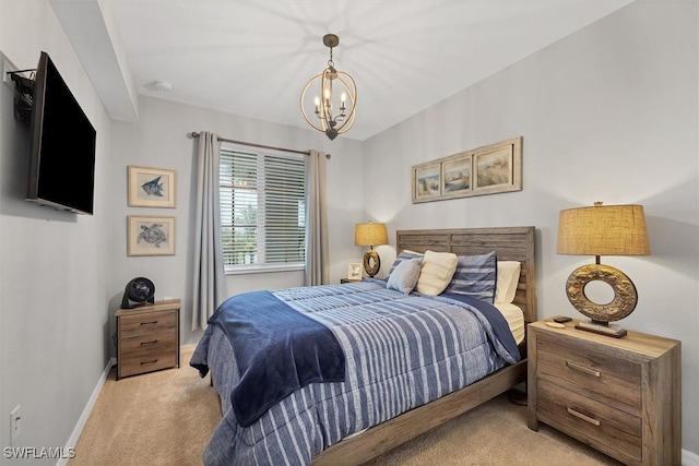 bedroom with a chandelier and light colored carpet