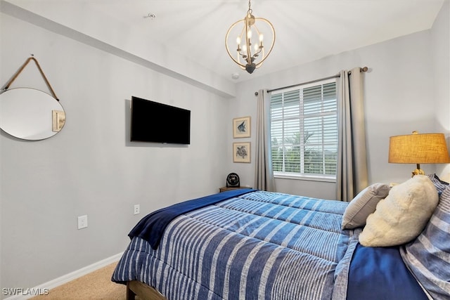 carpeted bedroom featuring an inviting chandelier