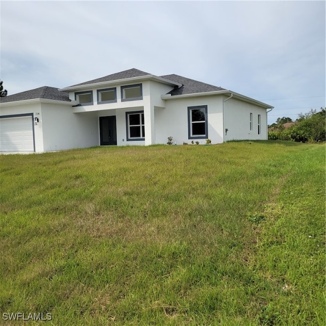 view of front of house featuring a garage and a front lawn