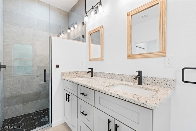 bathroom with vanity and a shower with door