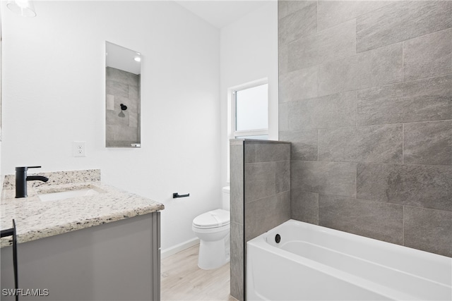 bathroom with wood-type flooring, toilet, and vanity