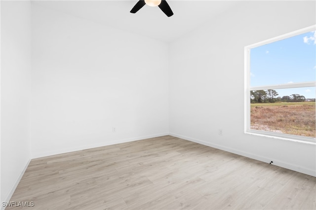 spare room featuring ceiling fan and light hardwood / wood-style flooring