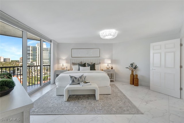 bedroom with access to exterior, an inviting chandelier, and multiple windows