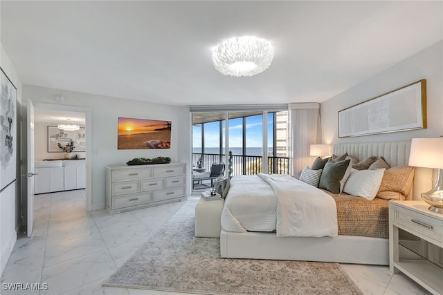 bedroom featuring a notable chandelier, expansive windows, and access to outside