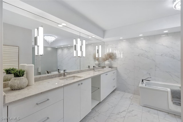 bathroom featuring a tub to relax in, vanity, tile walls, and toilet