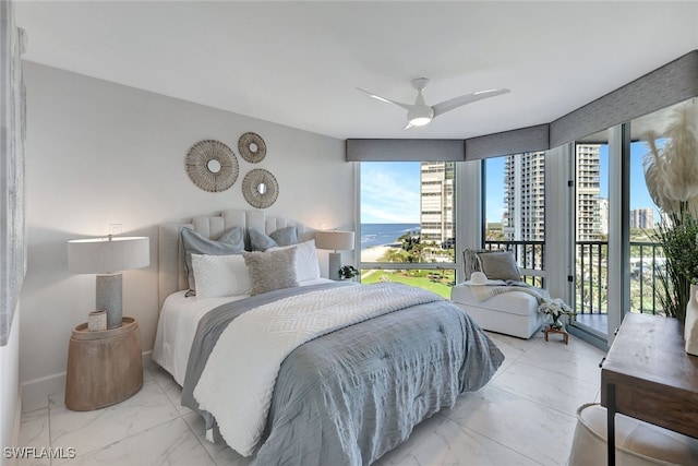 bedroom with access to exterior, a water view, and ceiling fan