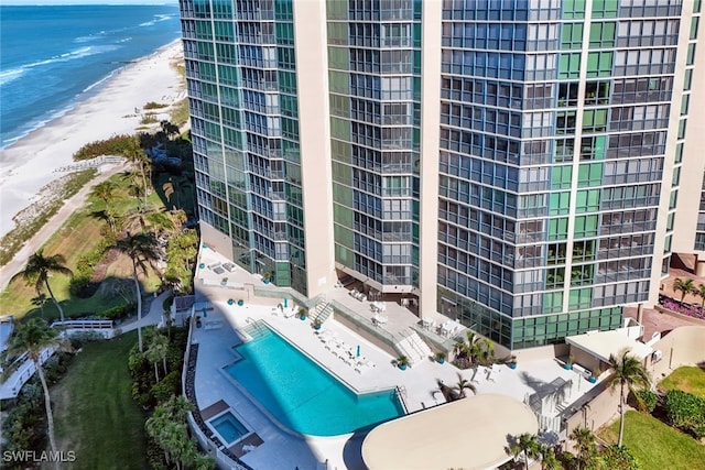 aerial view with a water view and a beach view