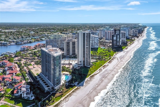 aerial view with a water view and a beach view