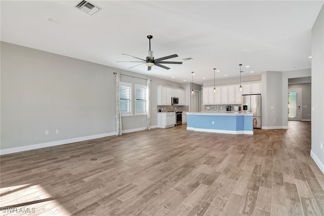 unfurnished living room featuring light hardwood / wood-style floors and ceiling fan