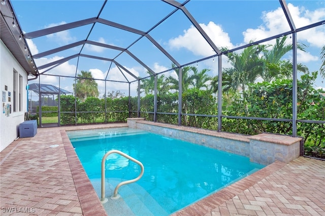 view of pool with a patio area and a lanai