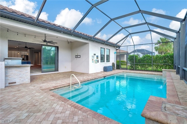 view of swimming pool featuring a patio area, pool water feature, a lanai, and ceiling fan