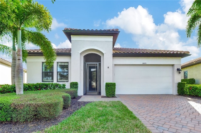 mediterranean / spanish-style home with a garage