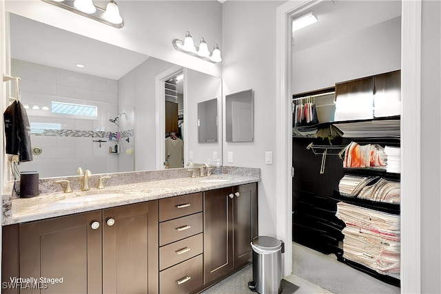 bathroom with vanity and tiled shower