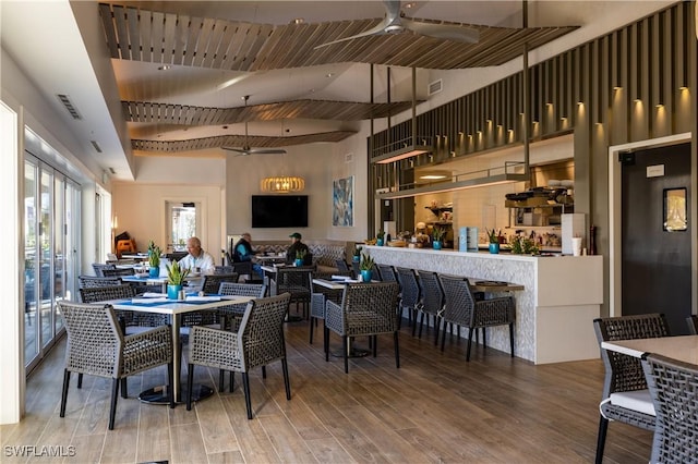 dining area with wood-type flooring, wooden ceiling, and ceiling fan