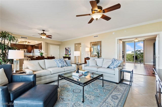 living room with light tile patterned flooring, ceiling fan, and ornamental molding