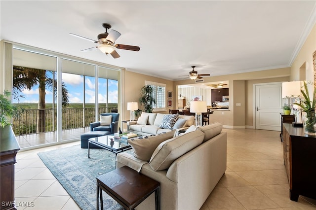 living room with expansive windows, crown molding, light tile patterned flooring, and ceiling fan