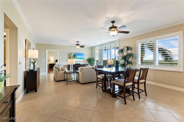 dining space with ceiling fan, ornamental molding, and light tile patterned floors