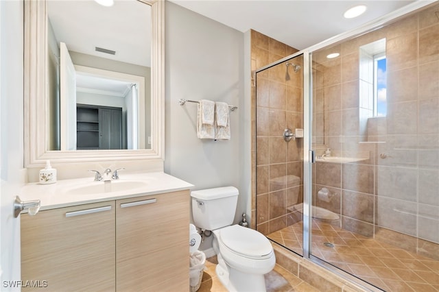 bathroom featuring vanity, an enclosed shower, crown molding, and toilet