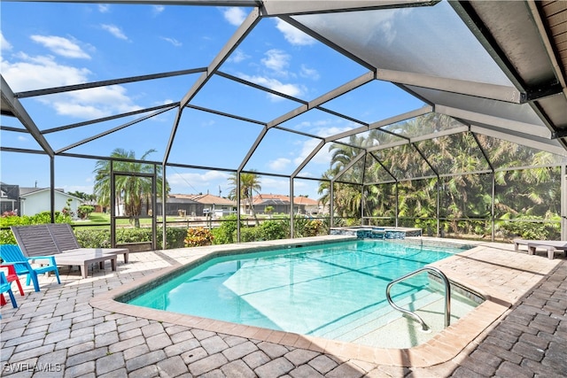 view of swimming pool with a patio, a lanai, and an in ground hot tub