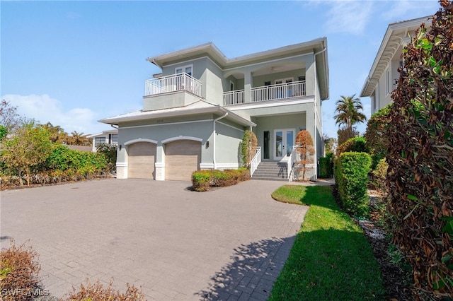 view of front of property with a garage and a balcony