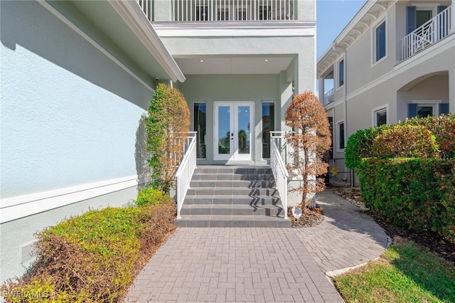 doorway to property featuring a balcony and french doors