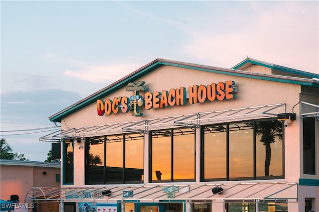 view of outdoor building at dusk