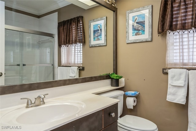 bathroom with toilet, crown molding, an enclosed shower, and vanity