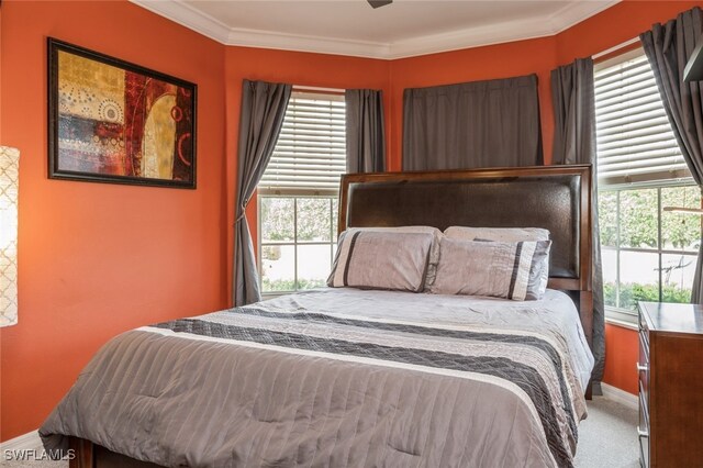 bedroom featuring carpet floors, crown molding, and ceiling fan