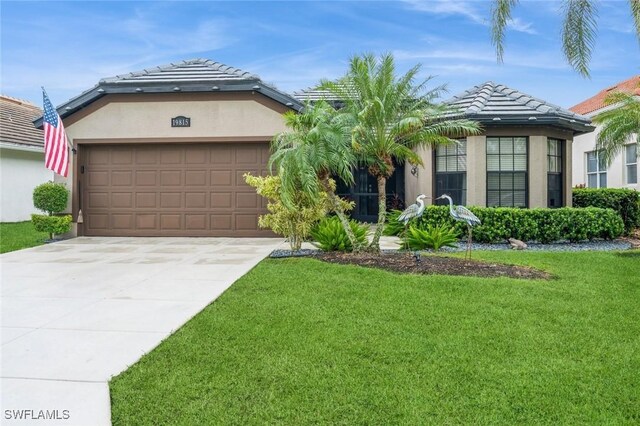 view of front of property with a garage and a front lawn