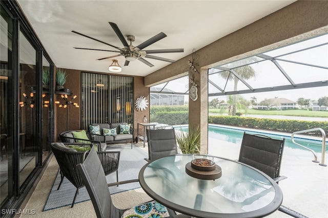 view of patio / terrace featuring ceiling fan, a lanai, and an outdoor living space