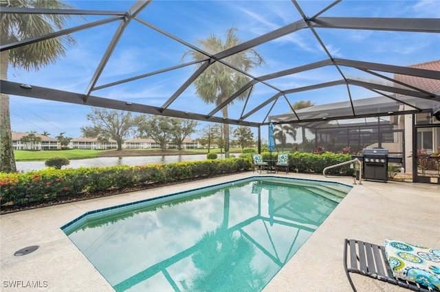 view of swimming pool featuring a patio area, area for grilling, glass enclosure, and a water view