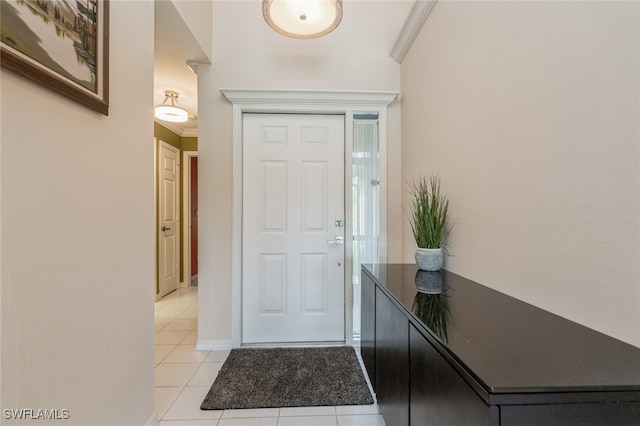 tiled entrance foyer with ornamental molding