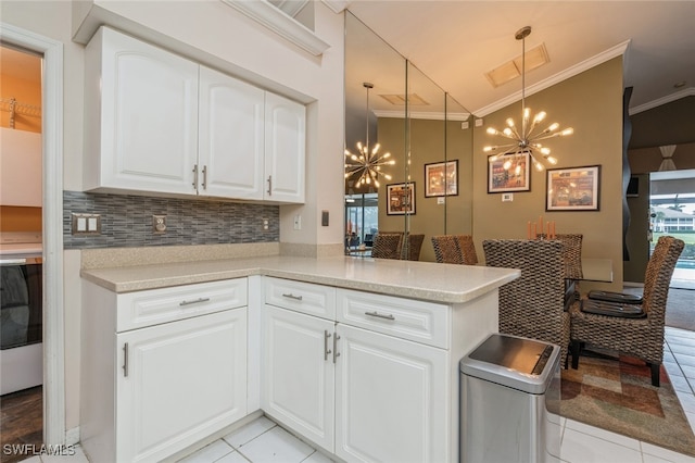 kitchen featuring white cabinets, pendant lighting, and kitchen peninsula