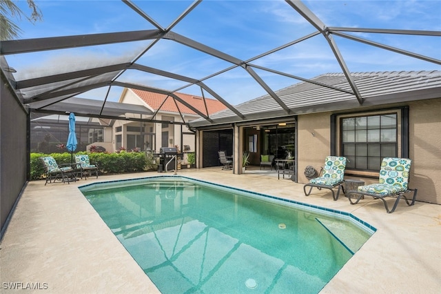 view of pool featuring a lanai, grilling area, and a patio area