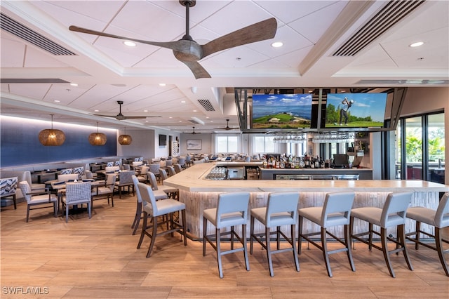 bar with light hardwood / wood-style floors and ceiling fan