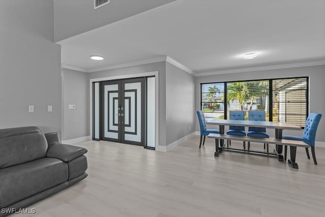 dining room with crown molding and light hardwood / wood-style flooring