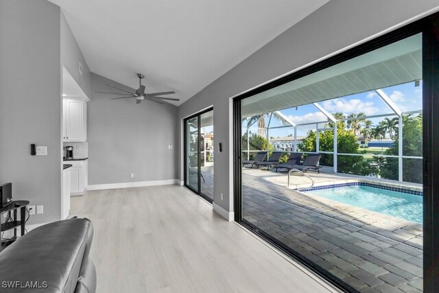 interior space with light hardwood / wood-style flooring, vaulted ceiling, and ceiling fan