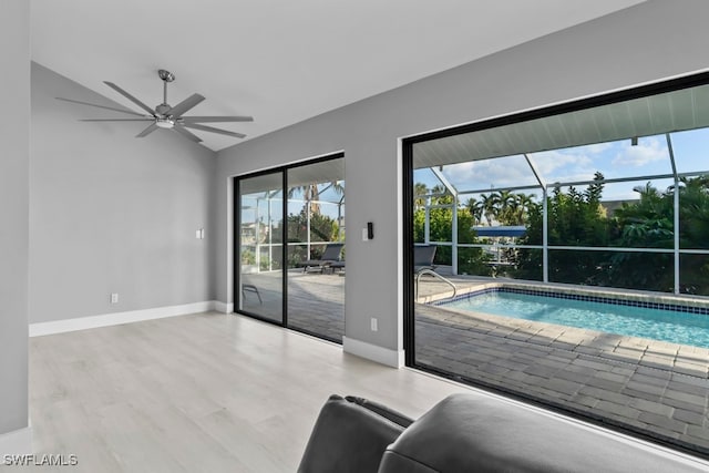 interior space featuring light hardwood / wood-style floors, ceiling fan, and lofted ceiling